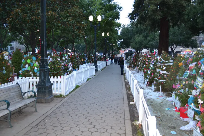 Decorated trees and a lit path at Christmas in the Park in downtown San Jose