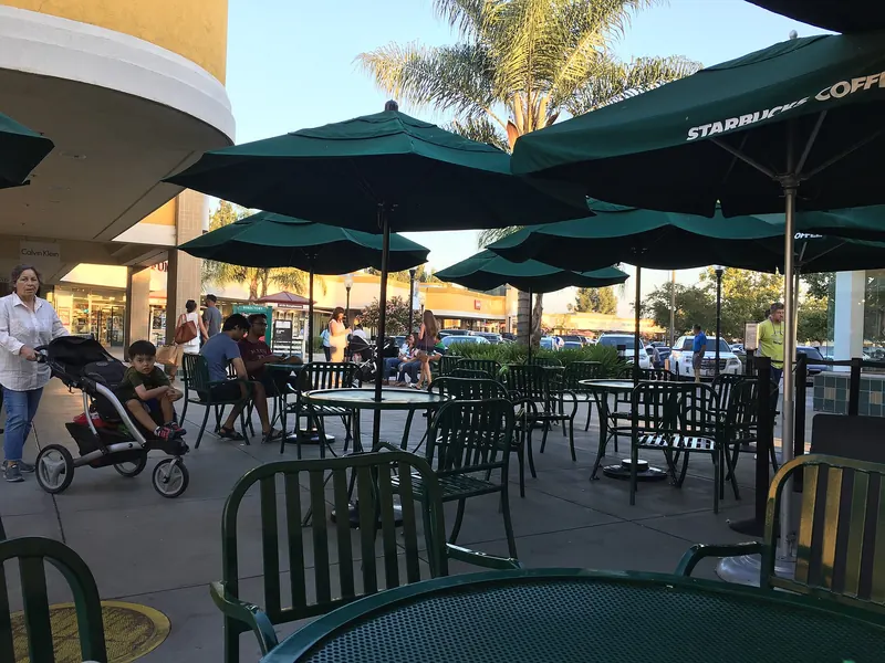 Outdoor tables and umbrellas at the Gilroy Premium Outlets food court
